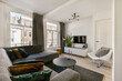 © ADDICTIVE STOCK - Modern living room with comfortable furnishings and ample light