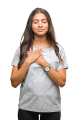 Sticker - Young beautiful arab woman over isolated background smiling with hands on chest with closed eyes and grateful gesture on face. Health concept.