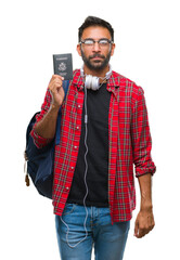 Poster - Adult hispanic student man holding passport of america over isolated background with a confident expression on smart face thinking serious