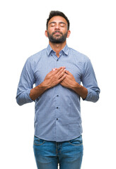 Sticker - Adult hispanic man over isolated background smiling with hands on chest with closed eyes and grateful gesture on face. Health concept.