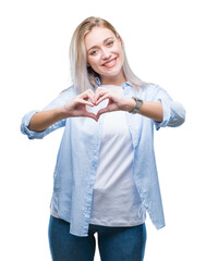 Poster - Young blonde woman over isolated background smiling in love showing heart symbol and shape with hands. Romantic concept.