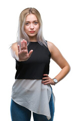 Sticker - Young blonde woman over isolated background doing stop sing with palm of the hand. Warning expression with negative and serious gesture on the face.