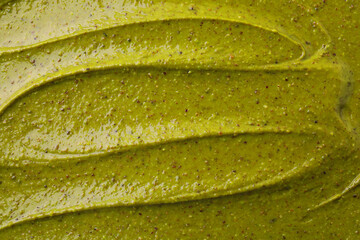 Poster - Tasty pistachio cream as background, top view