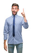 © Krakenimages.com - Young handsome business man over isolated background pointing finger up with successful idea. Exited and happy. Number one.