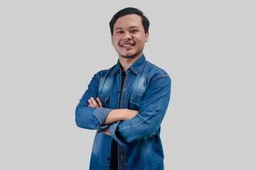 Young Asian Man folded arms looking at camera with happy face expression on isolated background