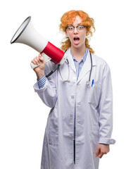 Sticker - Young redhead doctor woman holding megaphone scared in shock with a surprise face, afraid and excited with fear expression