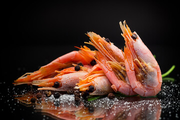 Wall Mural - boiled shrimp with spices on black background