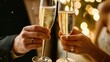 © Karolis - Couple toasting champagne with focus on clinking glasses and bubbles.