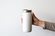 hand holding matte white Tumbler with lid vacuum Insulated. tumbler for mockup design