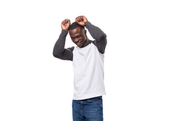 Wall Mural - young slender African guy dressed in a black and white sweatshirt posing for the camera