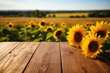 Empty Rustic Wooden Table Top On Blurred Sunflower Field Background For Product Display Or Montage