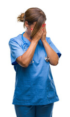 Sticker - Middle age senior nurse doctor woman over isolated background with sad expression covering face with hands while crying. Depression concept.