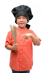 Wall Mural - Dark haired little child wearing chef uniform very happy pointing with hand and finger