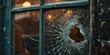 A broken glass window with a visible hole. This image can be used to depict vandalism, break-ins, or accidents involving broken windows