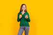© deagreez - Photo of teenager girl drinks tea during coffee break at college surfing videos youtube using phone isolated on yellow color background