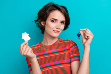 Sticker - Photo of satisfied adorable woman with bob hairstyle dressed striped t-shirt hold keys from new house isolated on teal color background