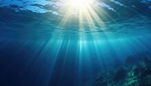 Blue Ocean Underwater With Sunrays Reaching Background