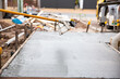© Austockphoto - tool about to work on a wet cement path