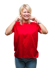 Poster - Young beautiful blonde woman wearing red t-shirt over isolated background covering ears with fingers with annoyed expression for the noise of loud music. Deaf concept.