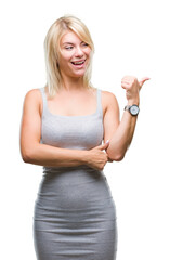 Poster - Young beautiful blonde woman over isolated background smiling with happy face looking and pointing to the side with thumb up.