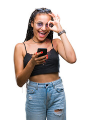 Canvas Print - Young braided hair african american with birth mark using smartphone over isolated background with happy face smiling doing ok sign with hand on eye looking through fingers