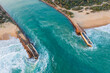 © Austockphoto - Aerial view of strong current pushing the sea between coastal breakwaters