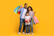 © Prostock-studio - Happy african american family holding gift and colorful shopping bags