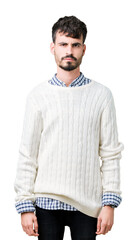 Wall Mural - Young handsome man wearing winter sweater over isolated background skeptic and nervous, frowning upset because of problem. Negative person.
