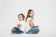 © Stefanie - Portrait of two children in studio with white background.