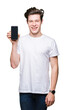© Krakenimages.com - Young man showing smartphone screen over isolated background with a happy face standing and smiling with a confident smile showing teeth