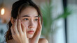 © Sasint - Dermatology, expression face worry asian young woman looking mirror hand touch facial at dark spot of melasma, freckles from pigment melanin, allergy sun. Beauty care, skin problem treatment, skincare