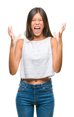 Wall Mural - Young asian woman over isolated background crazy and mad shouting and yelling with aggressive expression and arms raised. Frustration concept.