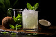 A highball glass with a coconut water and rum concoction, garnished with a coconut slice and a sprig of mint, set against a serene coconut white background.