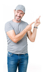 Wall Mural - Handsome middle age hoary senior man wearing sport cap over isolated background smiling and looking at the camera pointing with two hands and fingers to the side.