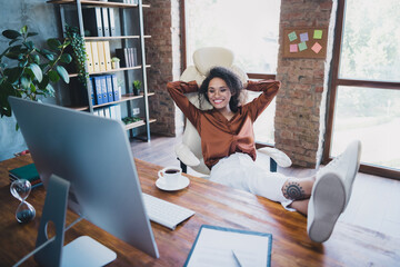 Poster - Full size portrait of charming peaceful company founder sit chair legs desk hands behind head watch video monitor workplace indoors