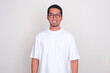 Adult Asian man wearing plain white t-shirt smiling at the camera
