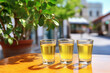 Lemon liquor in small glasses with on the street cafe table outdoors