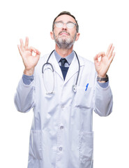 Sticker - Middle age senior hoary doctor man wearing medical uniform isolated background relax and smiling with eyes closed doing meditation gesture with fingers. Yoga concept.