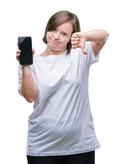 Poster - Young adult woman with down syndrome showing smartphone screen over isolated background with angry face, negative sign showing dislike with thumbs down, rejection concept