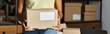 © LIGHTFIELD STUDIOS - cropped view of happy african american woman with box in hands while working hard, delivery, banner