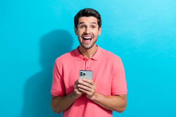 Aufkleber - Photo of crazy young man wearing pink t shirt hold smartphone shocked using 5g internet technology isolated on cyan color background