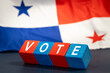 Panama vote, Word Vote  on wooden blocks against the background of the Panamanian flag, the concept of voting and taking part in important state and local elections