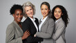 © MP Studio - Group of five women in professional attire, smiling and standing close together, with their hands joined in a sign of unity and support