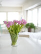Tulips on a table. Tulip bouquet in a sunny Scandinavian interior. Spring decoration background. Optimistic. Elegant room