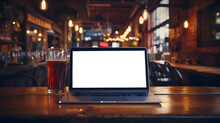 A Laptop And A Glass Of Beer On A Table