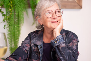 Sticker - Portrait of smiling senior caucasian old woman with glasses looking at side while sitting at cafe. Golden age grandmother serene lifestyle, freedom relax retirement concept