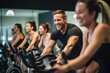 © Iftikhar alam - A lively group of individuals riding stationary bikes at a fitness center, Group of people participating in a spinning class, AI Generated