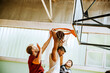 © Marko Geber - Young men playing basketball indoors