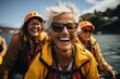 A joyful group of fashionable individuals, equipped with orange helmets and life jackets, stand confidently against a backdrop of clear blue sky and sparkling lake, their beaming smiles framed by sty