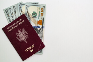 Closeup view of french passport and us dollar banknotes.